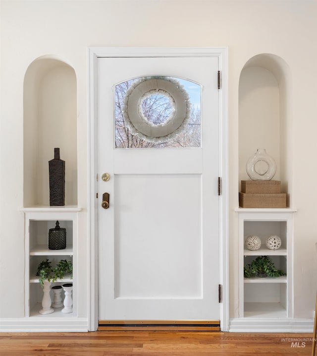 details featuring built in shelves and wood finished floors