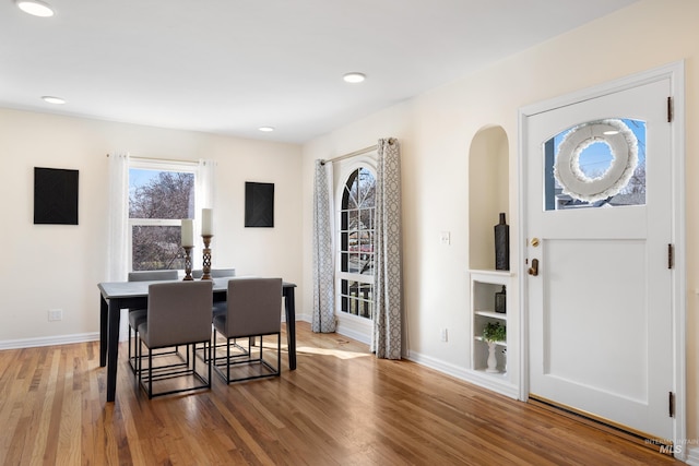 dining space with recessed lighting, baseboards, and wood finished floors