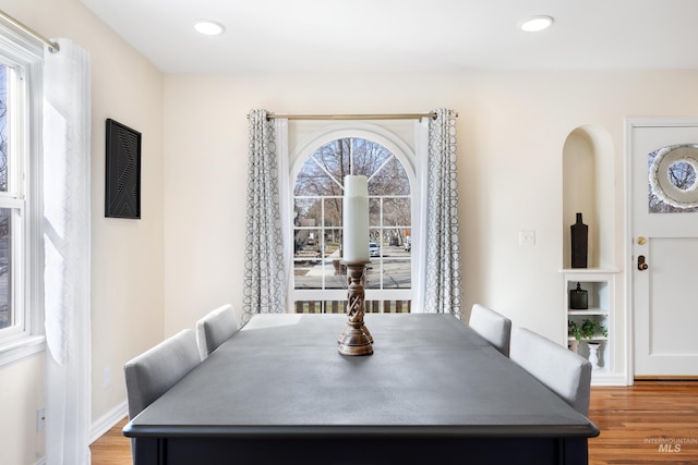 dining space with recessed lighting, baseboards, and wood finished floors