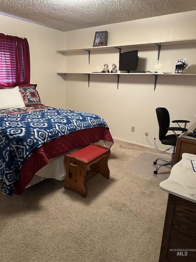 carpeted bedroom with a textured ceiling