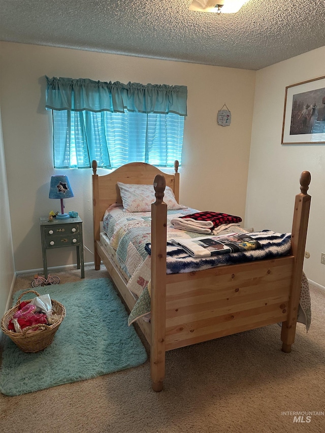 bedroom with carpet flooring and a textured ceiling