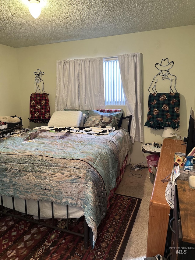 carpeted bedroom with a textured ceiling