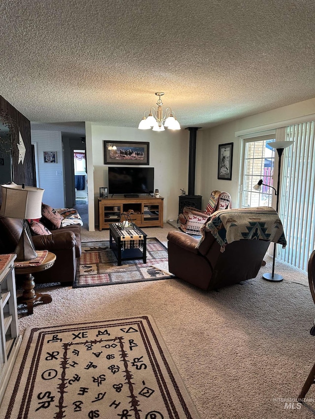 carpeted living room featuring a textured ceiling and a chandelier