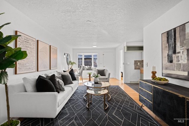 living area with wood finished floors and a textured ceiling