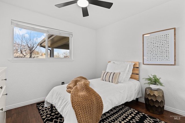 bedroom featuring a ceiling fan, wood finished floors, and baseboards