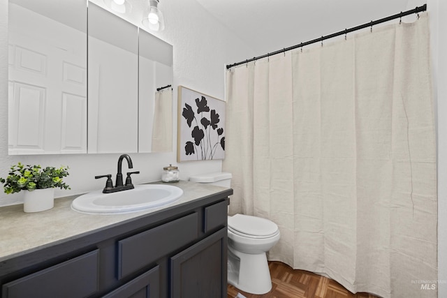 bathroom featuring toilet and vanity