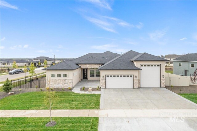 6201 W Redland Dr, Eagle, ID 83616 - view of front of house with fence, stone siding, and a garage