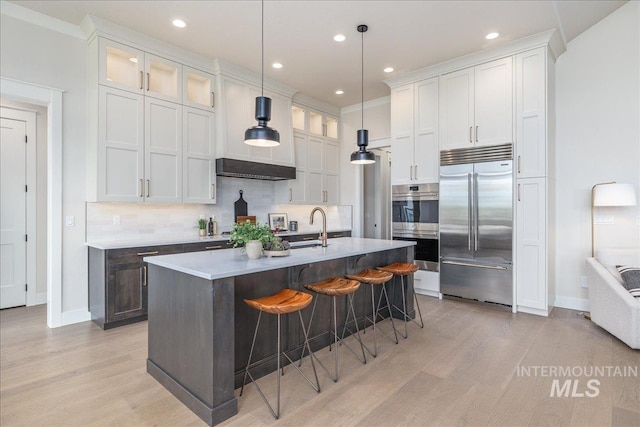 6201 W Redland Dr, Eagle, ID 83616 - kitchen with backsplash, stainless steel appliances, baseboards, and light wood finished floors