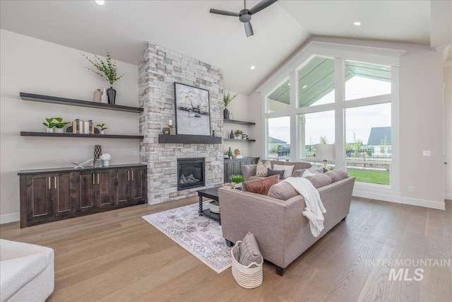 6201 W Redland Dr, Eagle, ID 83616 - living area featuring wood finished floors, a fireplace, baseboards, ceiling fan, and high vaulted ceiling