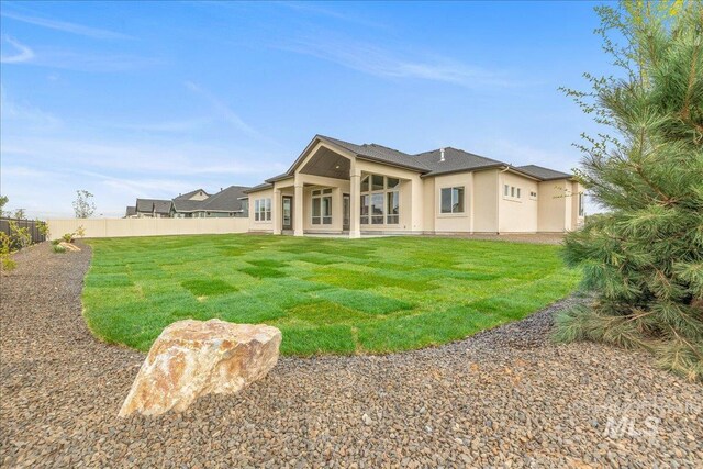 6201 W Redland Dr, Eagle, ID 83616 - back of property with a yard, a patio, fence, and stucco siding