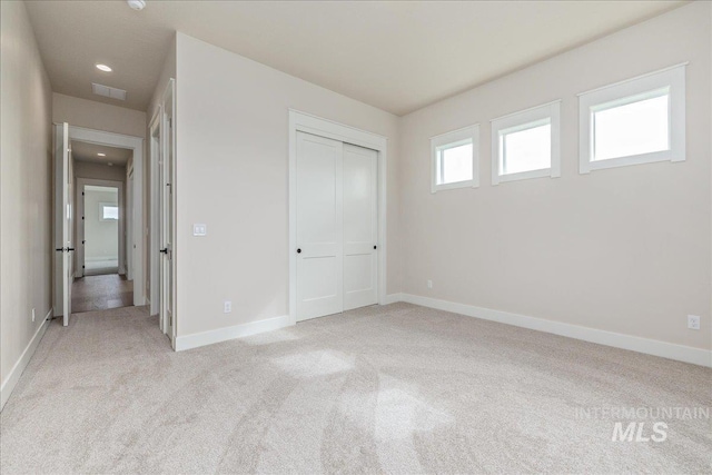 6201 W Redland Dr, Eagle, ID 83616 - unfurnished bedroom featuring light colored carpet, recessed lighting, baseboards, visible vents, and a closet