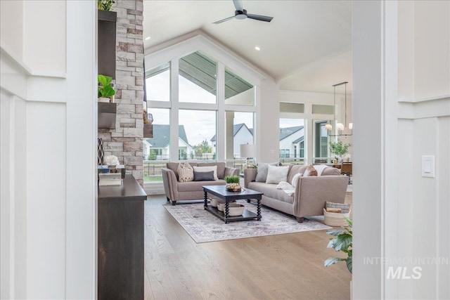 6201 W Redland Dr, Eagle, ID 83616 - living area featuring ceiling fan with notable chandelier, wood finished floors, and high vaulted ceiling