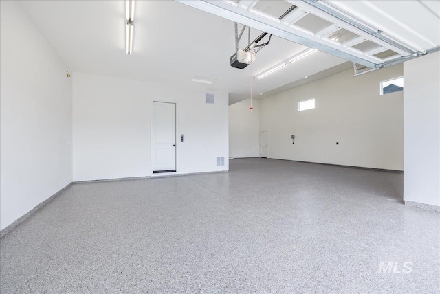 6201 W Redland Dr, Eagle, ID 83616 - garage featuring baseboards, visible vents, and a garage door opener