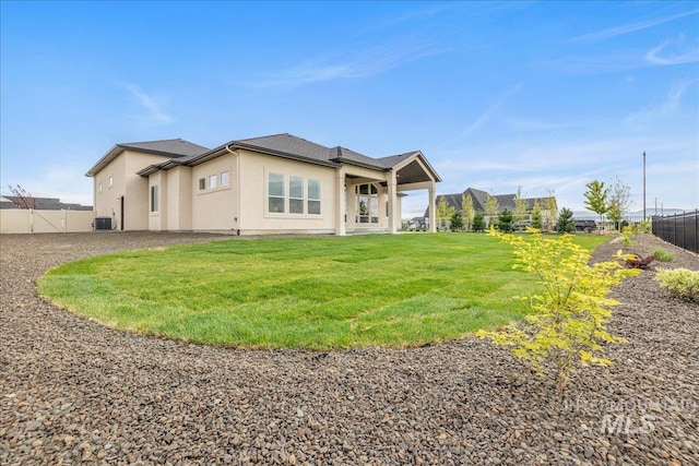 6201 W Redland Dr, Eagle, ID 83616 - back of property featuring stucco siding, central AC, fence, and a yard