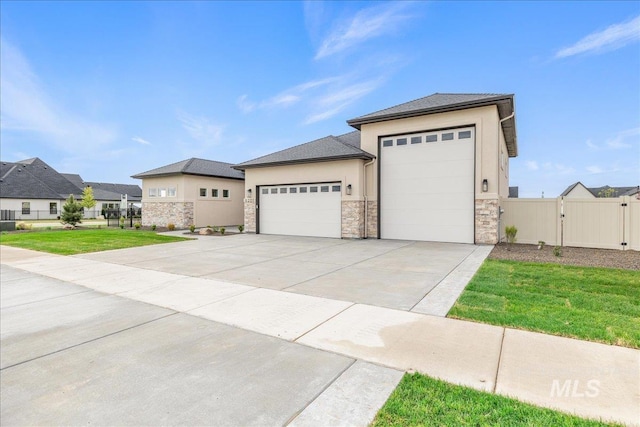 6201 W Redland Dr, Eagle, ID 83616 - prairie-style house featuring a gate, a garage, a front lawn, stone siding, and stucco siding