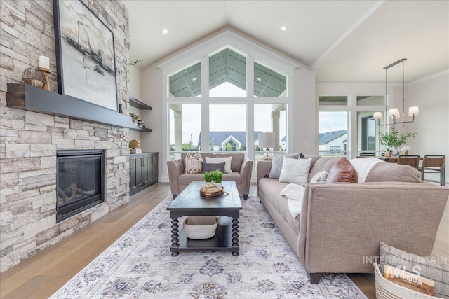 6201 W Redland Dr, Eagle, ID 83616 - living area with an inviting chandelier, vaulted ceiling, light wood-type flooring, and a stone fireplace