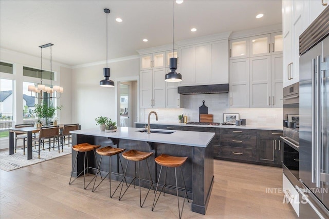 6201 W Redland Dr, Eagle, ID 83616 - kitchen featuring a breakfast bar, decorative backsplash, a sink, and light wood-style flooring