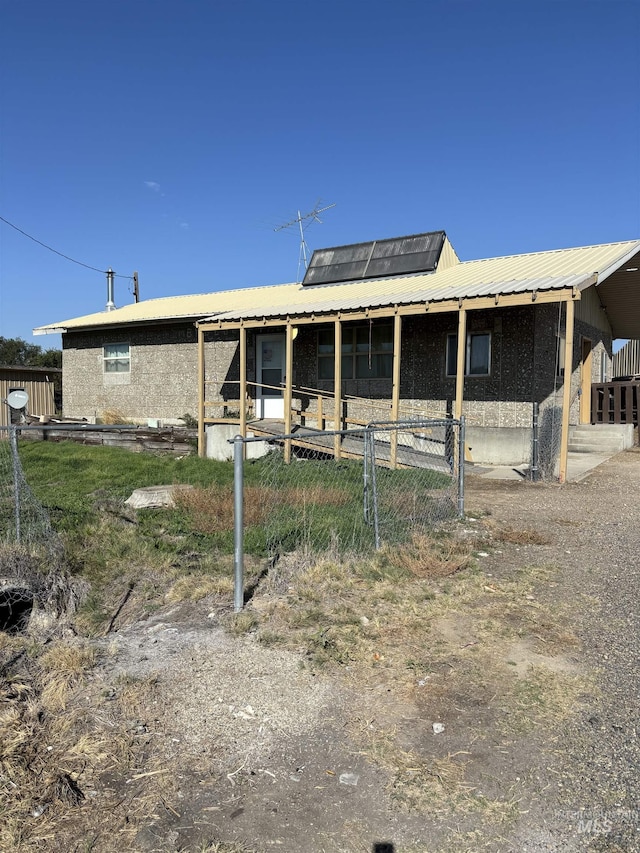 view of front facade featuring solar panels