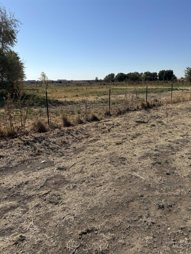 view of yard with a rural view