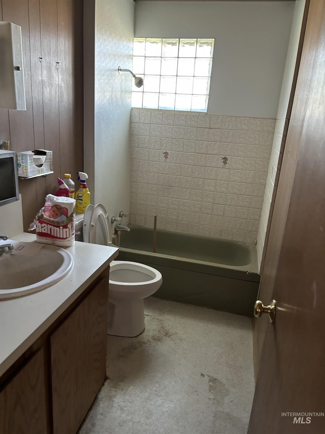 full bathroom featuring vanity, toilet, and tiled shower / bath