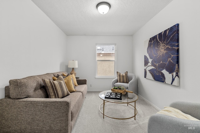 living room featuring a textured ceiling, carpet flooring, and baseboards