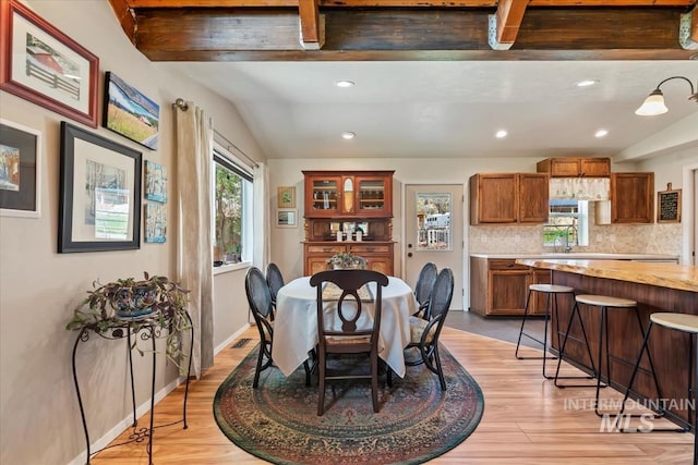 dining space with light wood-style floors, vaulted ceiling, and recessed lighting