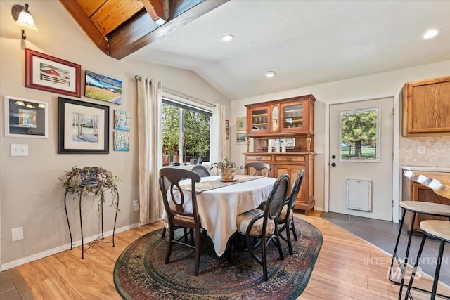 dining room featuring baseboards, recessed lighting, light wood finished floors, and vaulted ceiling