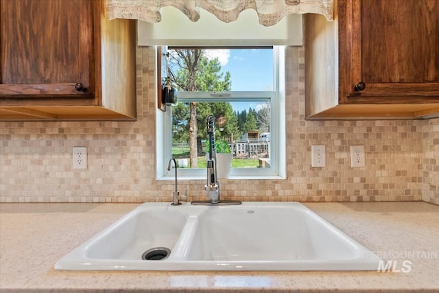room details with a sink and tasteful backsplash