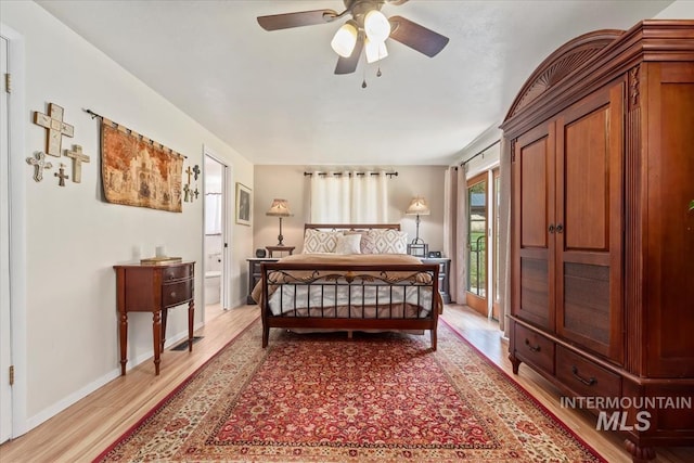 bedroom with connected bathroom, access to outside, baseboards, and light wood finished floors