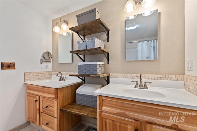 bathroom with two vanities, a sink, and tasteful backsplash