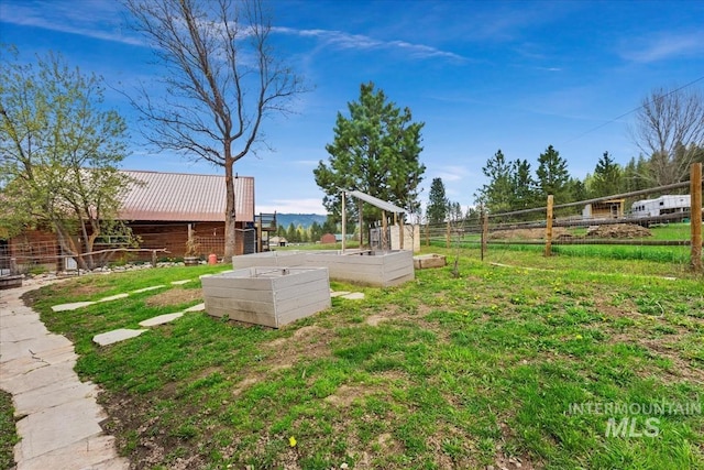 view of yard with fence and a garden