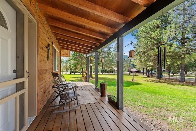 deck featuring a lawn and a porch