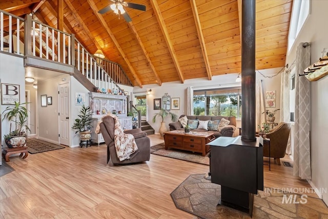 living room with a ceiling fan, wood finished floors, wooden ceiling, high vaulted ceiling, and stairs