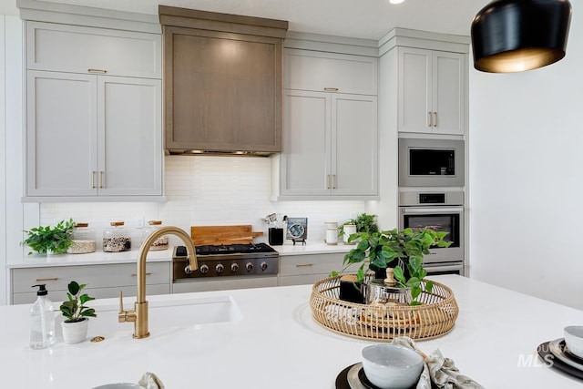 kitchen with stainless steel microwave, recessed lighting, backsplash, and light countertops