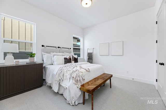 carpeted bedroom with baseboards