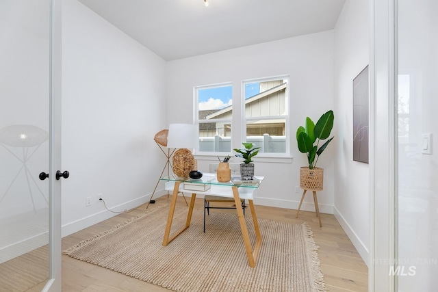 home office featuring baseboards and light wood-type flooring
