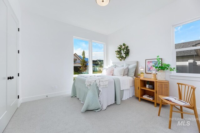 carpeted bedroom featuring baseboards