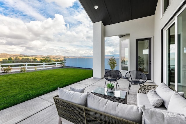 view of patio / terrace with fence and an outdoor living space