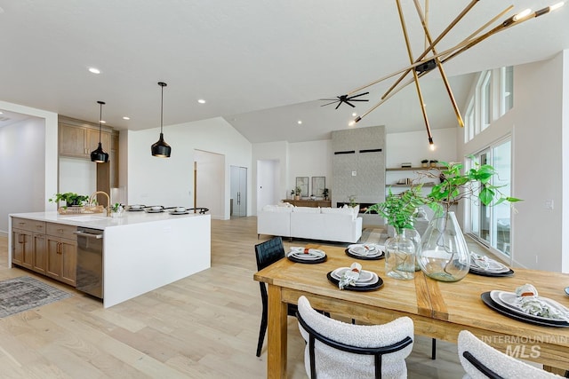 dining room with lofted ceiling, light wood-style flooring, baseboards, recessed lighting, and a ceiling fan