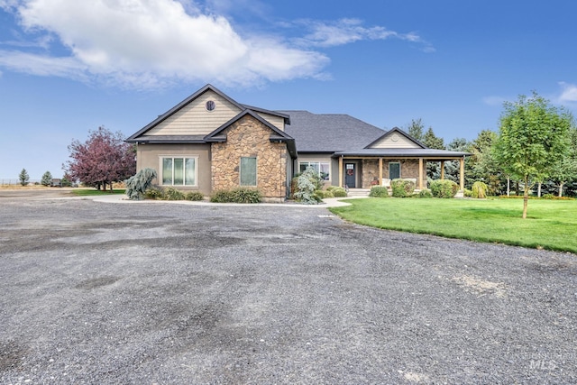 craftsman-style home featuring a front yard and covered porch