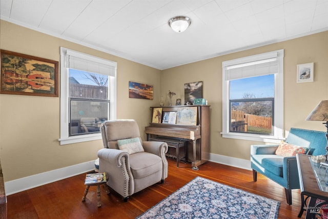 living area with baseboards and hardwood / wood-style floors