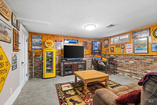 carpeted living area featuring a textured ceiling, brick wall, and visible vents