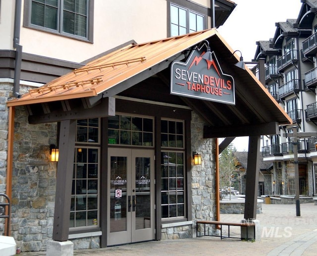 780 Village Dr Unit 308, Donnelly, ID 83615 - view of exterior entry featuring french doors, stone siding, and stucco siding