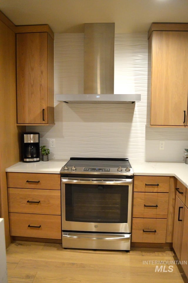 780 Village Dr Unit 308, Donnelly, ID 83615 - kitchen with light wood-type flooring, light countertops, ventilation hood, and stainless steel electric stove