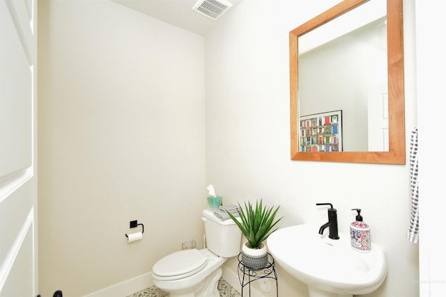 bathroom featuring sink, toilet, and tile patterned floors