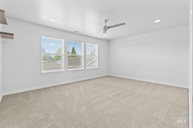 unfurnished room featuring ceiling fan, light carpet, recessed lighting, and baseboards