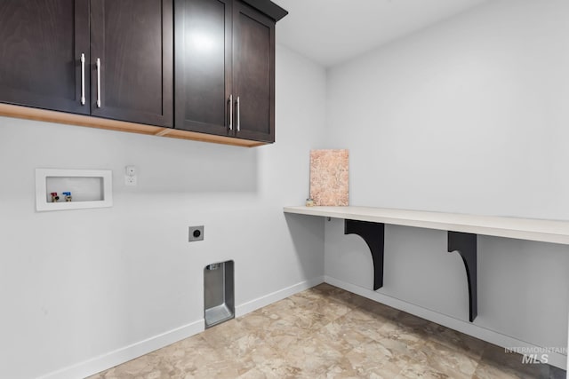 washroom with cabinet space, hookup for an electric dryer, hookup for a washing machine, and baseboards