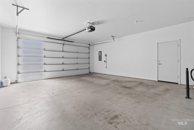 garage featuring a garage door opener and electric panel