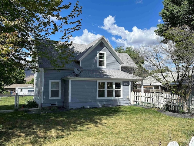 rear view of house with a yard