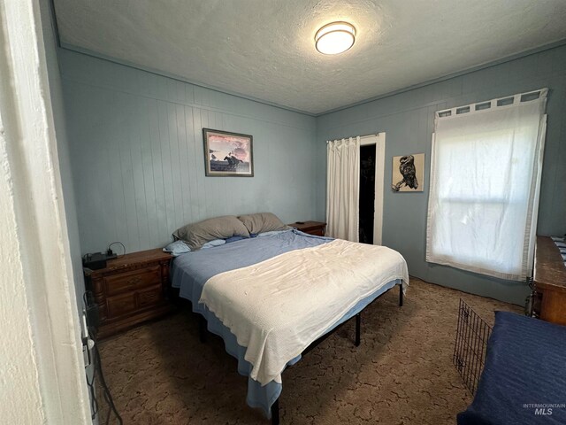 carpeted bedroom with a textured ceiling